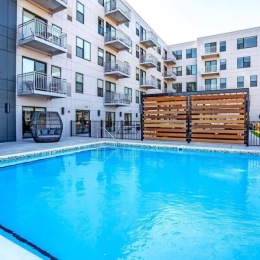 a pool in front of a multi story building
