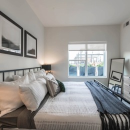 a bedroom with a bed and a window