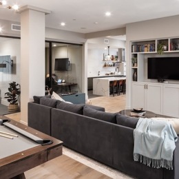 a lounge with a couch pool table and tv