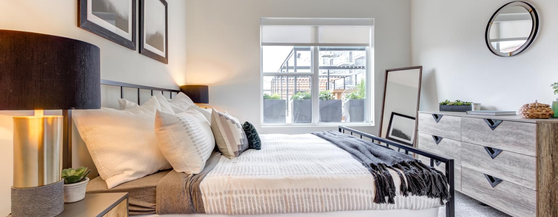 a bedroom with a bed and a mirror