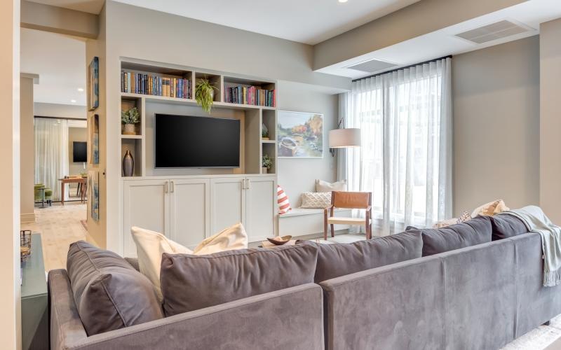a living room with a tv and couches