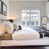 a bedroom with a bed and a mirror