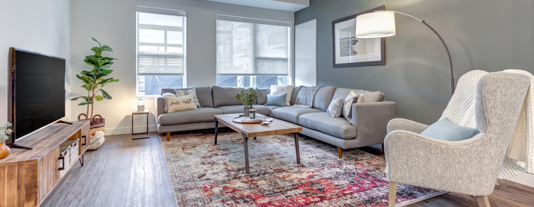 a living room with a red rug